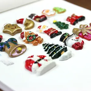 Detailed view of colorful resin Christmas charms including Santa, snowmen, and bells