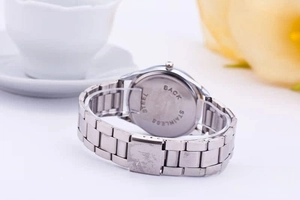 Close-up of Geneva silver stainless steel watch back featuring engraved metal detail