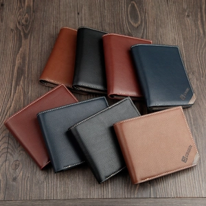 Men's minimalist leather bifold wallets in various colors on a wood surface