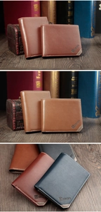 Close-up of leather men's bifold wallets with elegant stitching and metal logo detail