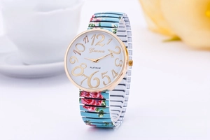 Close-up of Geneva floral stretch watch with light blue rose band and golden numeral dial