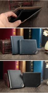 Detail of minimalist leather wallets with white stitching and textured lychee pattern