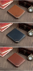 Close-up of classic leather wallets in black and brown on vintage wood surface