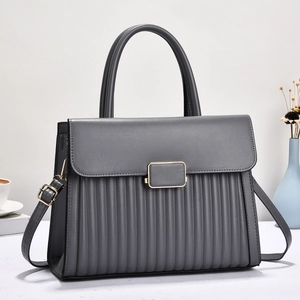 Detail view of dark grey leather tote bag with vertical pleats and golden metal lock