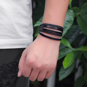 Handmade multilayer black woven leather wave bracelet for men and women on wrist