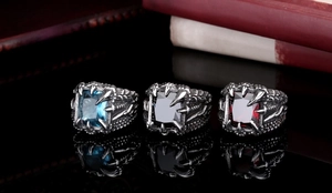 Detailed view of gothic dragon claw rings with blue, black, and red square zircon stones