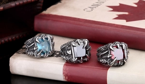 Detailed view of vintage punk dragon claw rings with blue, black, and red gemstones