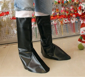 Detail of black faux leather Santa boots with white plush trim for Christmas cosplay costumes