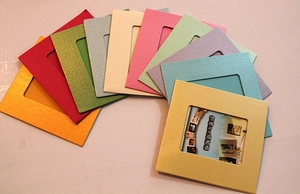 Detailed close-up showing a colorful variety of square DIY hanging paper photo frames