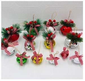 Detail of Christmas iron bells with pine needles, cones and red checkered bows for trees