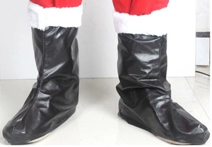 Detail of black faux leather Santa Claus boot covers with white faux fur trim and red trousers
