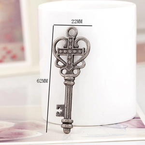 Close-up of vintage bronze key pendant with cross design and 62mm x 22mm dimensions