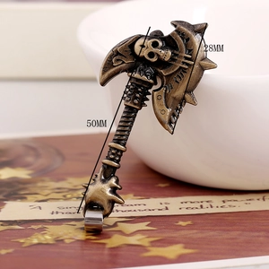 Macro detail of bronze axe pendant showing 50mm height and intricate skull carving