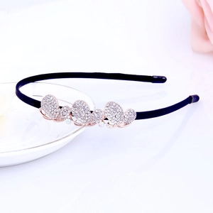 Detail of rose gold butterfly headband adorned with crystals on a white plate