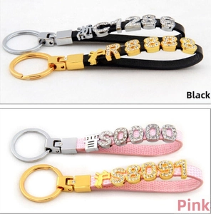 Detailed view of DIY leather wristbands with rhinestone letters and metal hardware