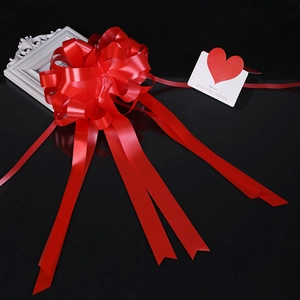 Close-up of red double-layered pull bow ribbon for wedding car and gift decoration