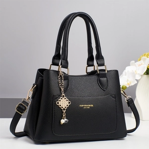 Elegant black lychee grain leather handbag with gold hardware and pearl charm