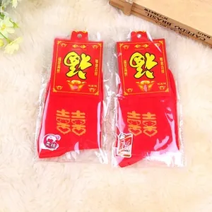 Detail of red wedding cotton socks with gold Double Happiness print and festive packaging