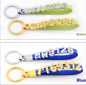 Detail of DIY leather keychain featuring diamond-encrusted chrome letters and snake texture