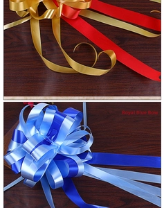 Detail of royal blue and gold large double-layered ribbon pull bows for wedding decoration