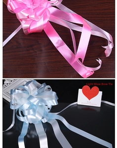 Detail of satin wedding pull bows in pink and light blue colors for car decoration