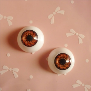 Macro view of 20mm brown resin doll eyes with detailed iris texture for DIY crafts
