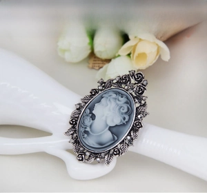 Macro shot of vintage cameo ring with silver rose frame and grey crystal accents