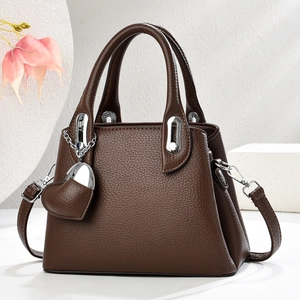 Brown lychee leather tote bag for women with silver hardware and heart charm detail