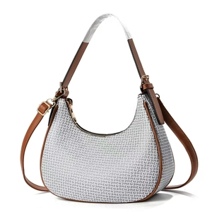 Beige monogram hobo shoulder bag with brown leather straps and adjustable crossbody belt