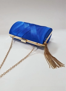 Close-up of royal blue satin evening clutch with woven pleats and gold tassel detail