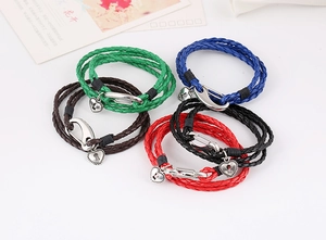 Detailed view of woven leather bracelets in multiple colors with heart lock charms
