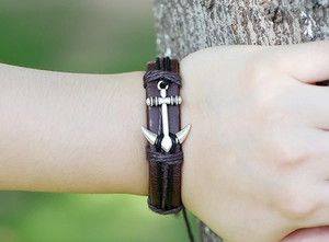 Close-up of vintage multilayer braided leather anchor bracelet with textured alloy buckle