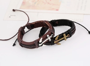 Detail of multilayer woven leather anchor bracelets in brown and black tones