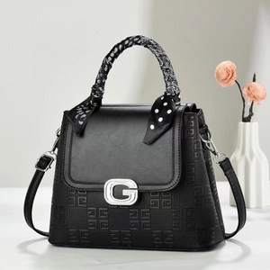 Fashionable black leather handbag with silver G buckle and polka dot silk scarf handle