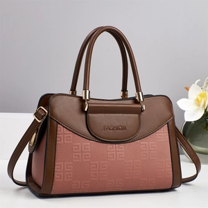 Close-up of pink and brown tote bag featuring square embossed texture and golden hardware