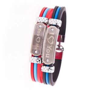 Detail of couple bracelets with silicone straps, metal plates and You & Me engravings