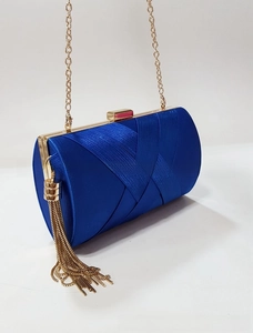 Detail of royal blue satin evening clutch with woven pleats and gold metal tassel