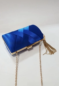 Detail of blue satin evening clutch with woven texture, gold tassels and chain strap