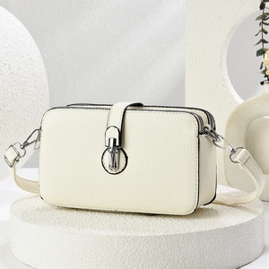 Elegant off-white layered shoulder bag with silver lock and high-quality pebble texture
