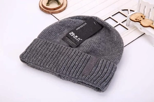 Close-up of dark grey thick rib-knit beanie with warm fleece lining and brand tag