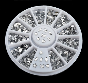 Close-up of 12-slot wheel containing silver heart, bow, and star nail art rhinestones