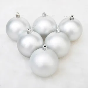 Set of 6 matte silver Christmas balls with hanging strings on white faux fur background