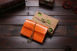 Vintage orange leather leaf notebook with string tie and decorative gift box packaging