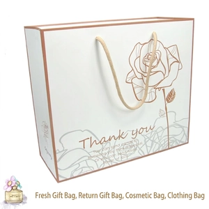 Elegant white rose paper gift bag with gold trim and braided rope handles for favors