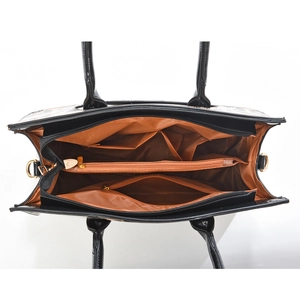 Top view of black shell bag interior showing multiple functional compartments and gold hardware