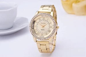 Elegant gold-tone ladies quartz watch with rhinestone bezel and metal link strap