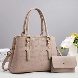Detail view of retro crocodile pattern tote bag set with matching wallet and gold hardware