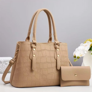Detail of crocodile pattern handbag and wallet set with gold studs and shoulder strap