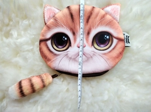 Detail of 3D lifelike plush cat coin purse with orange stripes and fluffy tail zipper