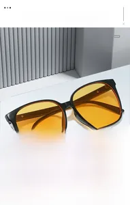 Macro detail of retro square sunglasses with thick black frames and orange lenses